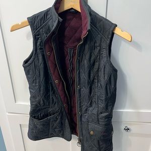 Barbour women’s vest dark navy with plum interior.  Like new.